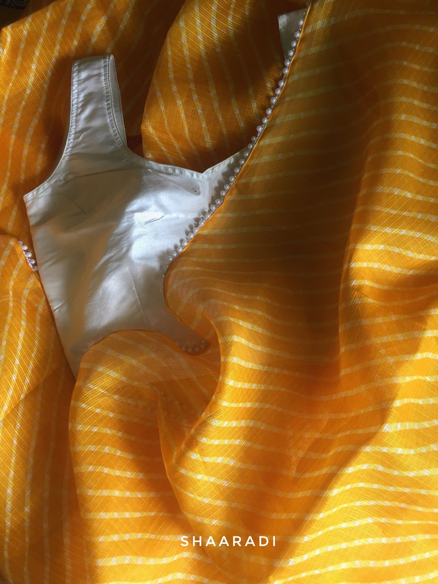 Pearls in Yellow Leheriya Saree